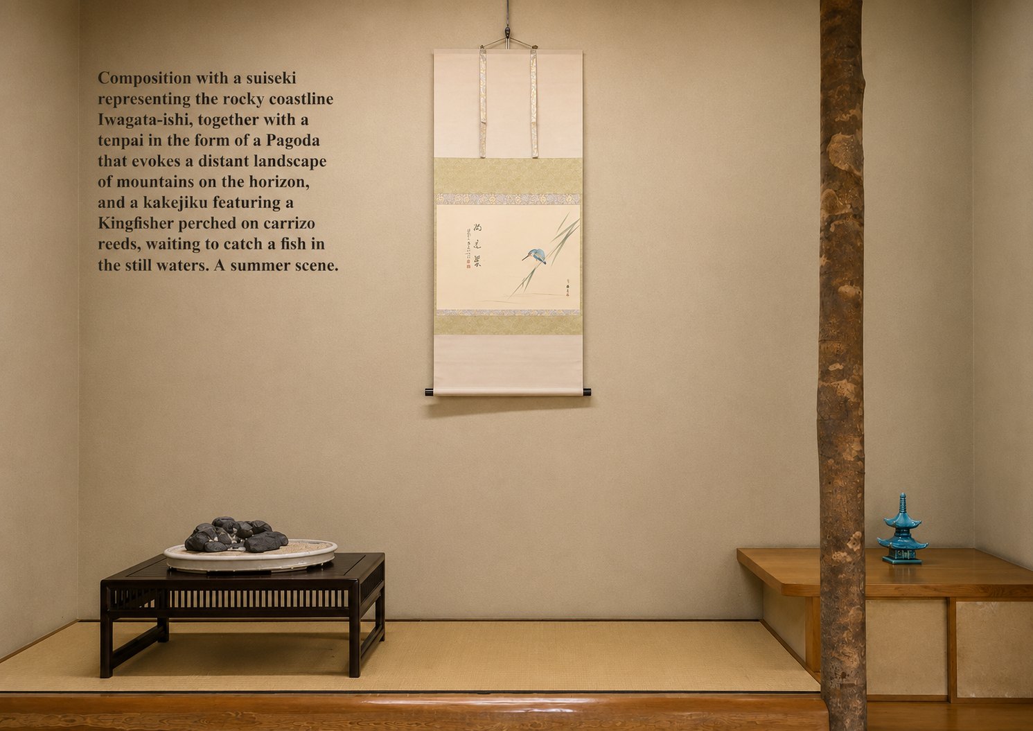 A summer display in which every element contributes to a unified seasonal atmosphere. The suiseki, presented in a suiban with sand, is accompanied by a small pagoda that evokes the temples and mountain landscapes of Japan, where architecture and nature exist in quiet harmony. Completing the composition, the hanging scroll depicts a kingfisher in an aquatic setting, subtly introducing the presence of water. Together, these elements build both a coherent natural landscape and a mood of coolness and tranquility. © Bonsai Keidō Ippū
